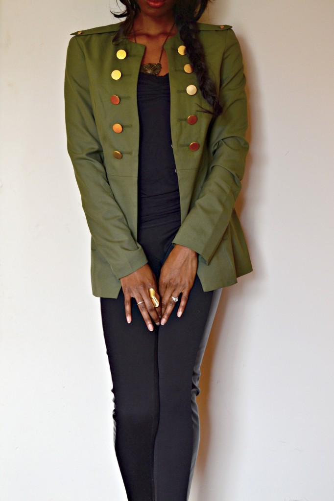 military style jacket over a monochromatic outfit, with gold details