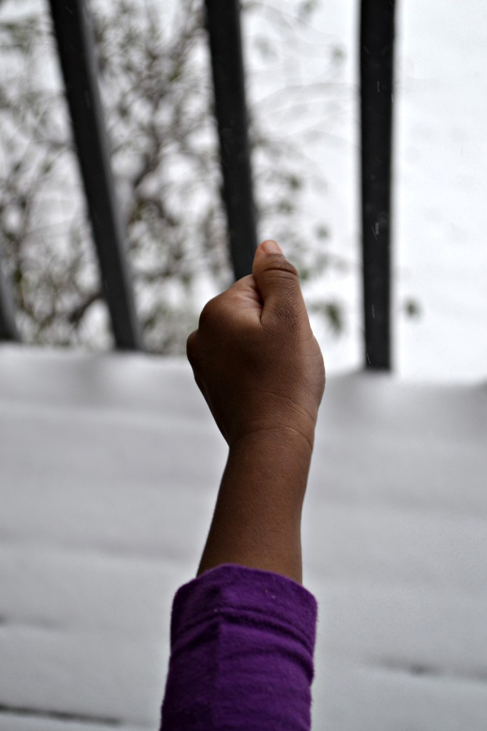 little kid hand catching snow