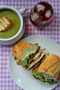 Delicious grilled pesto chicken sandwich paired with pea pesto soup and a glass of iced tea. Perfect for summer and fall meal plans!