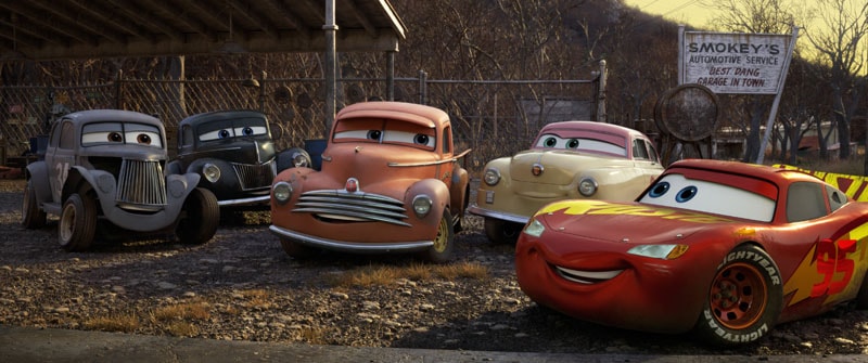 MEET THE LEGENDS — Lightning McQueen comes hood to hood with a group of characters who represent the roots of stock car racing—and provide a link to Lightning’s late coach and mentor, Doc Hudson. From left: River Scott (voice of Isiah Whitlock Jr.), Junior “Midnight” Moon (voice of Robert Glenn “Junior” Johnson), Smokey (voice of Chris Cooper), Louise “Barnstormer” Nash (voice of Margo Martindale), and Lightning himself (voice of Owen Wilson). “Cars 3” opens in U.S. theaters  on June 16, 2017. ©2017 Disney•Pixar. All Rights Reserved.