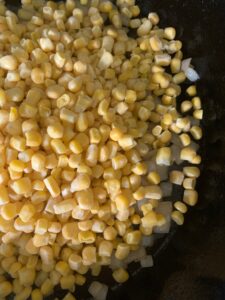 frozen corn and chopped fresh onion in cast iron skillet