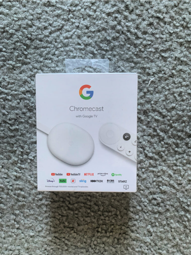 Photo of a google chromecast on a grey carpet